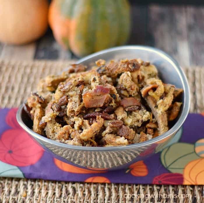 Bacon Pecan Stuffing in a silver bowl with pumpkins in the background