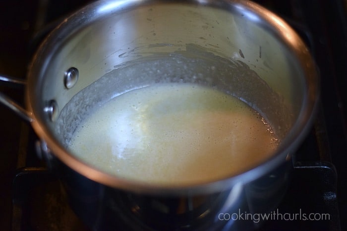 simmering the roux in a saucepan.