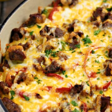 Breakfast Pizza with Hash Brown Crust topped with sausage, peppers and melted cheese.