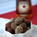 Chocolate Bourbon Truffles with a bottle of Four Roses Bourbon in the background.