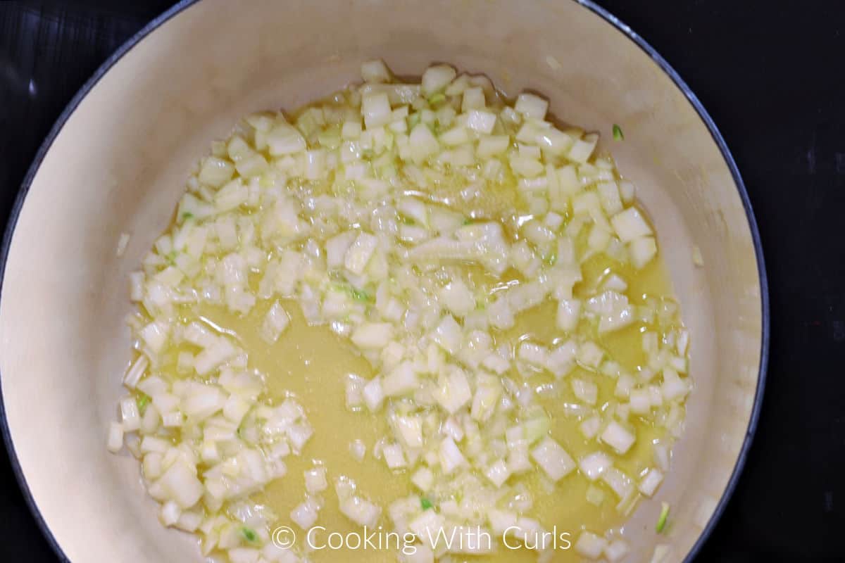 Diced onion and butter simmering in a Dutch oven. 