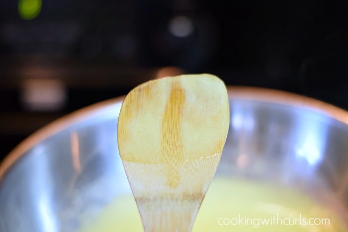 Lemon Curd on the back of a wooden spoon.
