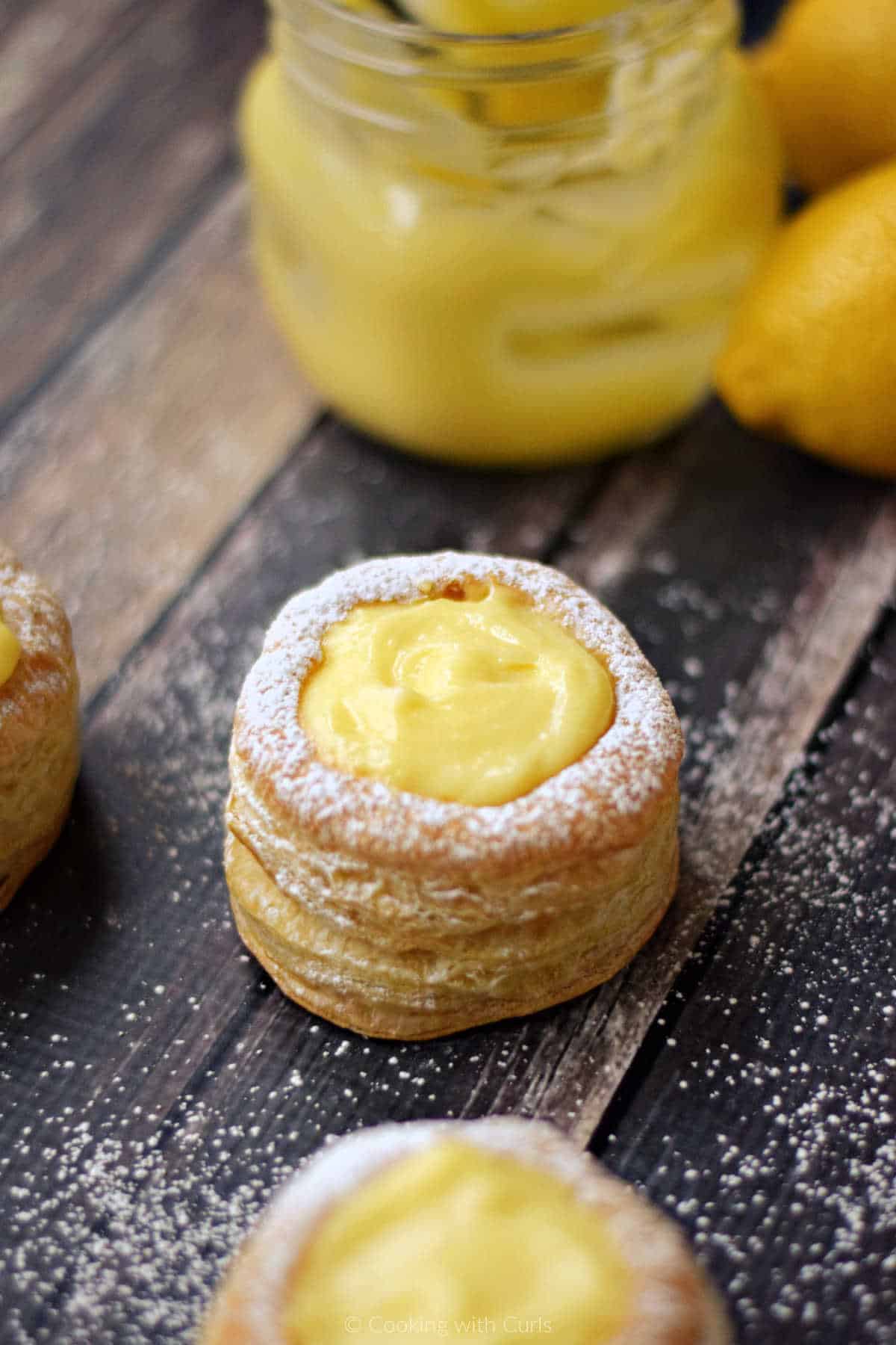 Puff pastry tarts filled with lemon curd and sprinkled with powdered sugar.