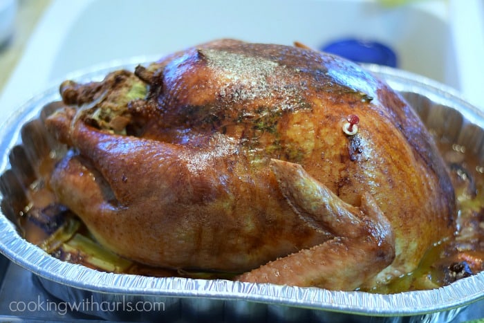 Herb Roasted Turkey in a metal roasting pan sitting next to the sink.
