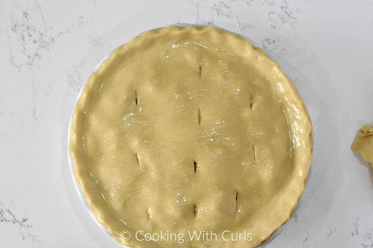 Slits cut into top pie crust for venting. 