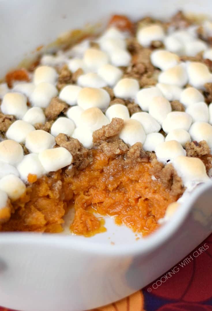 Candied Sweet Potatoes in a white casserole dish topped with streusel and optional marshmallows