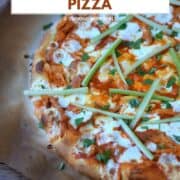 Buffalo Chicken Pizza topped with celery sticks on charred parchment paper and title graphic across the top.