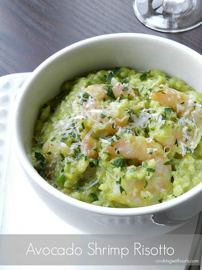 Avocado-Shrimp-Risotto topped with shredded Parmesan cheese in a white bowl.