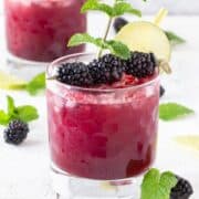 Blackberry mint Gin Bramble in a short glass garnished with blackberries.