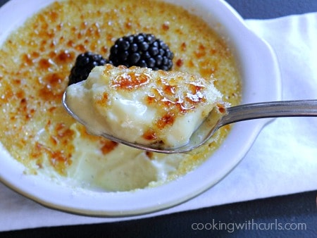 Creme Brûlée topped with two blackberries.