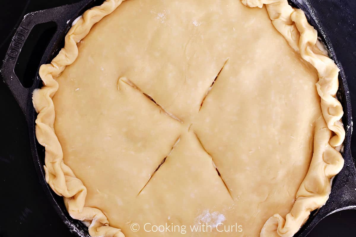 Four vent lines cut into the top of the pie crust. 