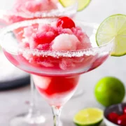 Frozen pink drinks in margarita glasses.