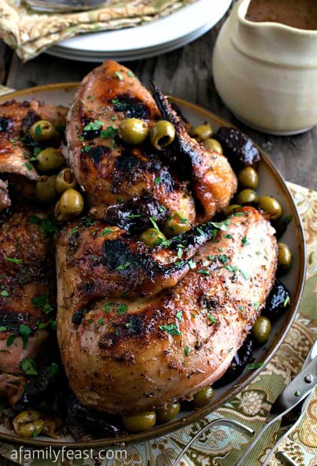 chicken Marbella with green and black olives in a large bowl.