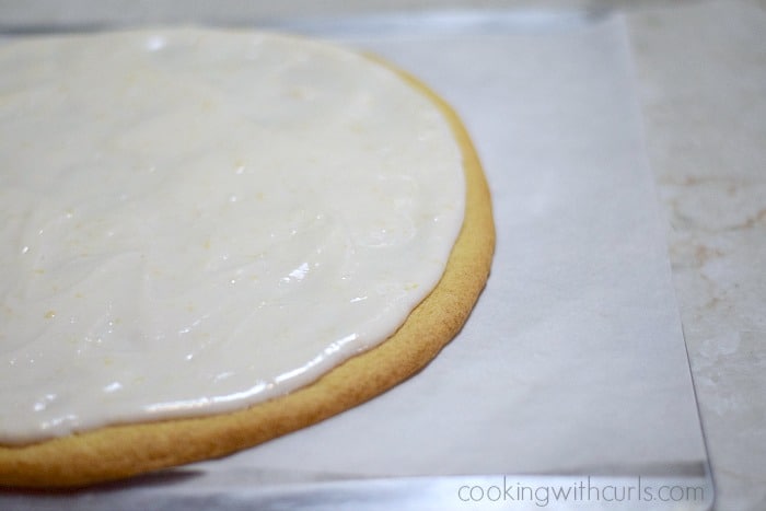Cream cheese spread over a giant sugar cookie.
