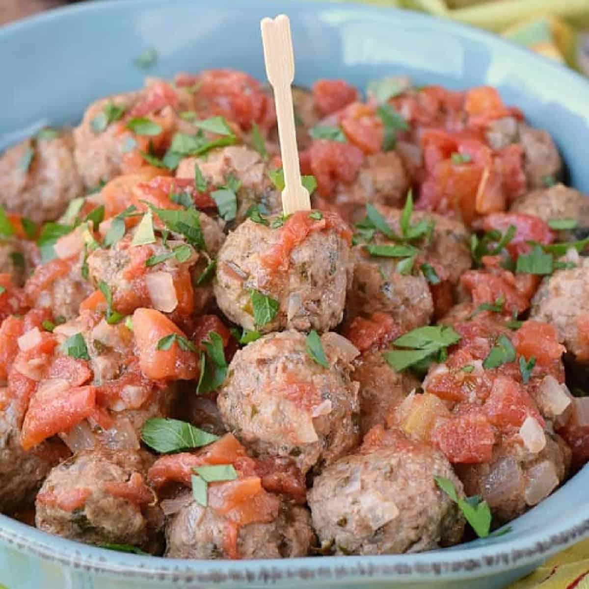 a blue bowl filled with meatballs.