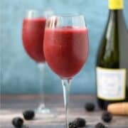 Blended berries and wine in two wine glasses with title graphic across the top.