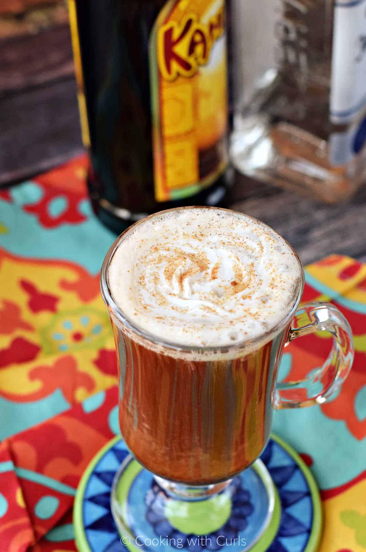 Mexican Coffee Cocktail topped with whipped cream and grated cinnamon shown at an angle.