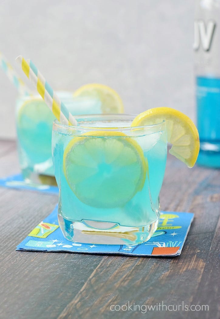 A Blue Lemonade Cocktail is the perfect beverage to cool you off this summer! cookingwithcurls.com