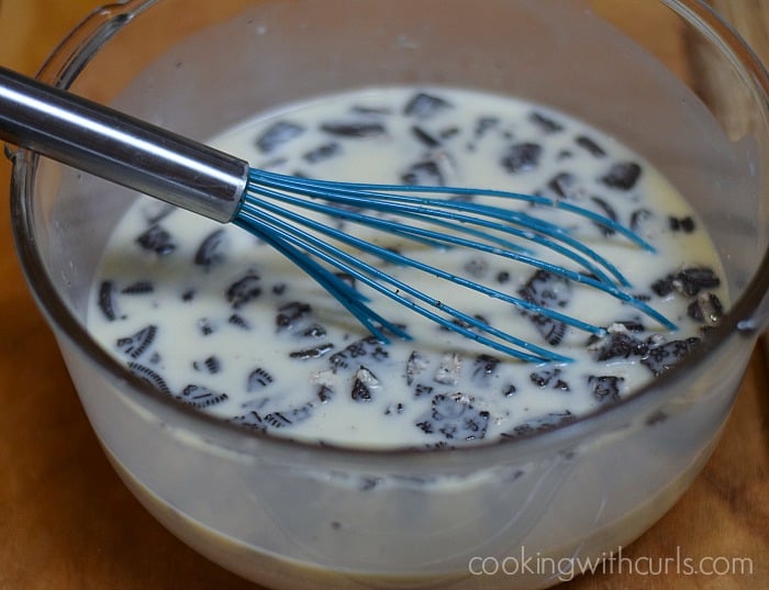 Pudding mix, milk and chopped cookies whisked together in a bowl.