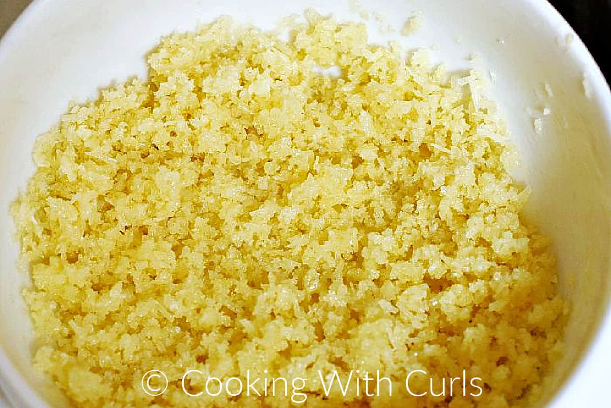 Panko breadcrumbs, parmesan cheese, and butter mixed together in a small bowl. 