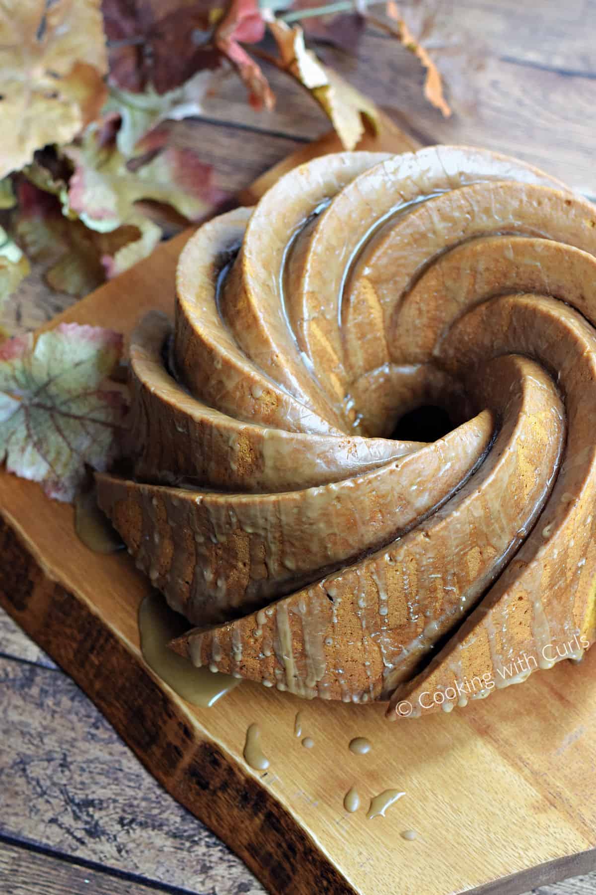 A swirl patterned bundt cake on a wood serving board.