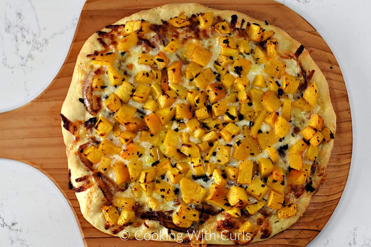 Baked Butternut Squash and Sage Pizza on a wood pizza peel. 