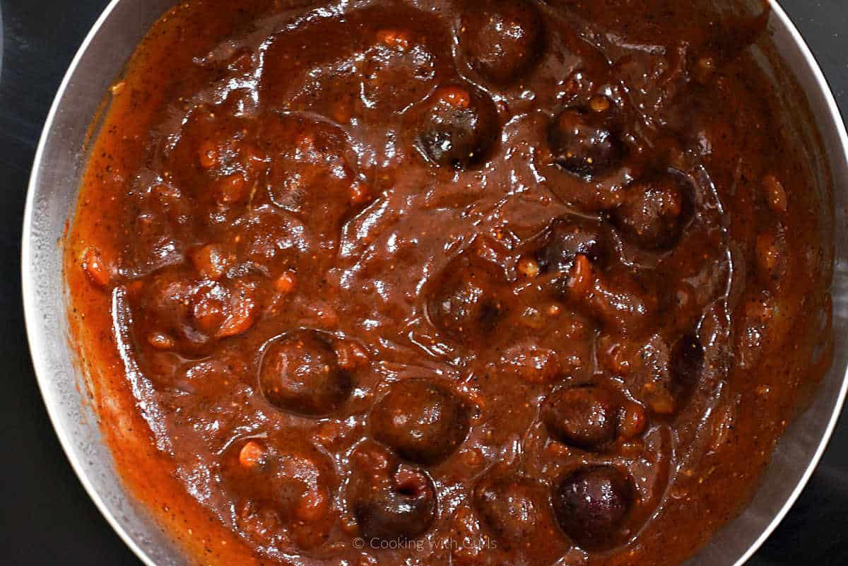 Cherry chipotle bbq sauce simmering in a saucepan.