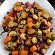 Oven Roasted Brussels Sprouts and Squash with Dried Cranberries on a large platter.