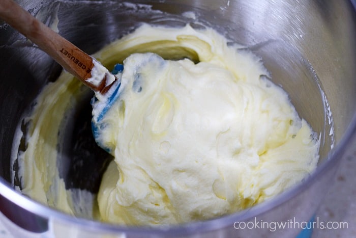 Egg whites being folded into the egg mixture with a silicone spatula.