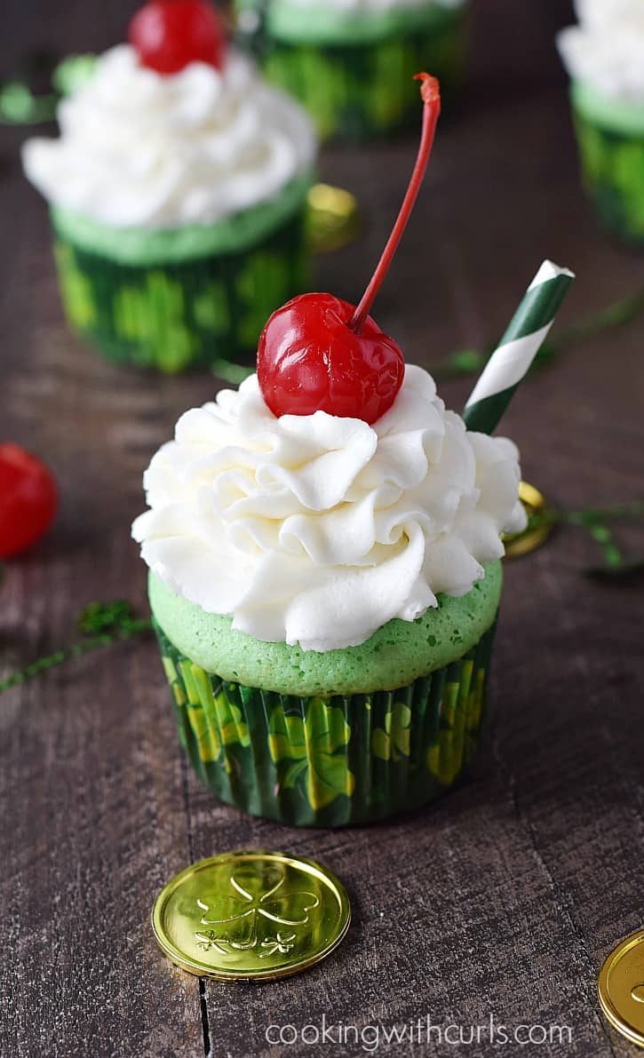 Minty flavored Boozy Shamrock Shake Cupcakes topped with Godiva® White Chocolate Buttercream are the perfect treat anytime of year | cookingwithcurls.com
