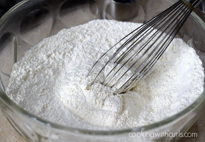 Flour, baking powder, baking soda, sugar and salt in a large glass bowl with a wire whisk.