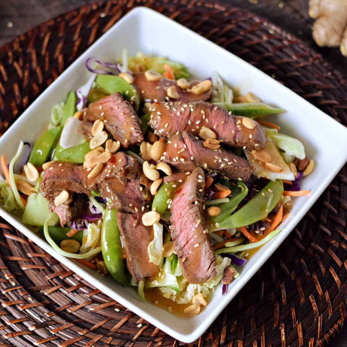 Bok choy and vegetables topped with sliced beef, peanuts and dressing.