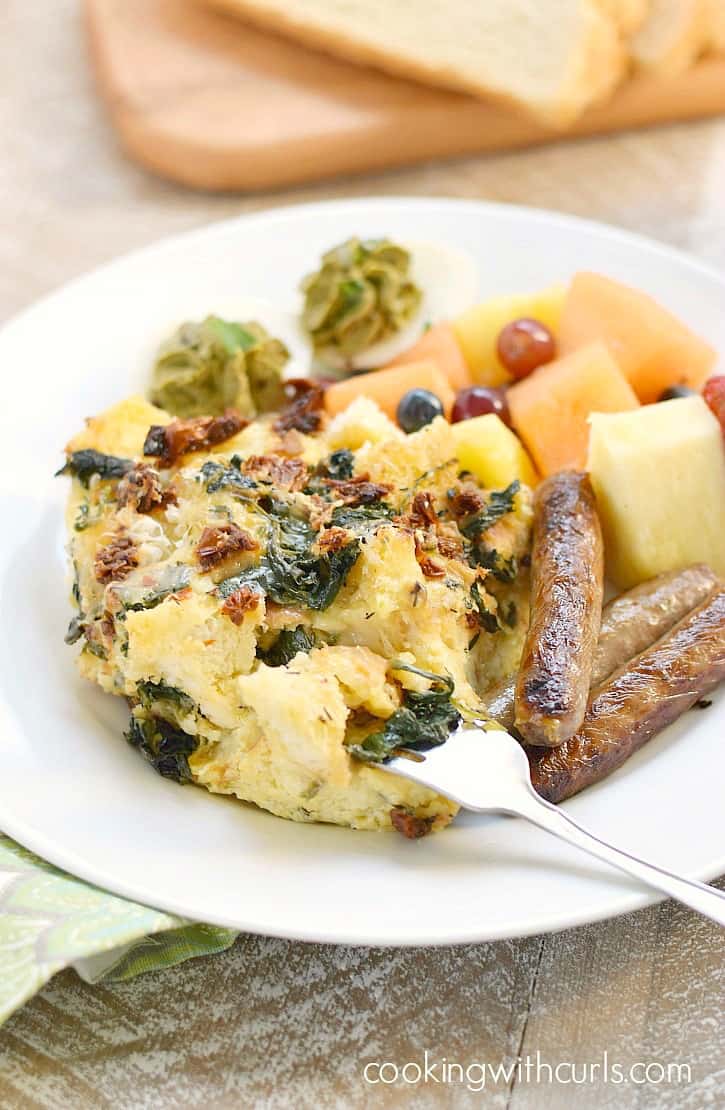 Sourdough Breakfast Strata with sun-dried tomatoes, spinach and fontina cheese is perfect for brunch!! cookingwithcurls.com
