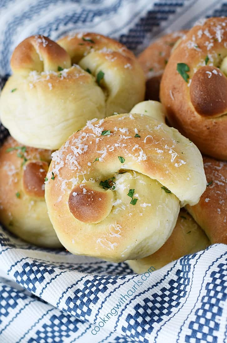 Garlic Knots fresh out of the oven and sprinkled with Parmesan cheese | cookingwithcurls.com
