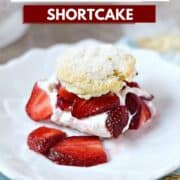 Sugar topped biscuit cut in half and filled with whipped cream and sliced strawberries on a dessert plate and title graphic across the top.