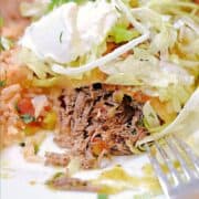Shredded beef spilling out of fried tortilla casing topped with shredded lettuce, and salsa next to Spanish rice with title graphic across the top.