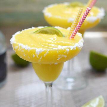 These Frozen Tropical Margaritas are like sunshine and ocean breezes in a coconut rimmed glass | cookingwithcurls.com