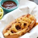 Barbecue Bacon Hot Dogs cooked on the grill and topped with crispy onion rings | cookingwithcurls.com