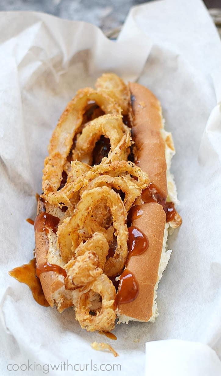 Barbecue Bacon Hot Dogs grilled to perfection and topped with crispy onion rings and extra sauce | cookingwithcurls.com