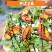 Pizza topped with grilled peaches, arugula leaves, crumbled goat cheese and balsamic drizzle with title graphic across the top.