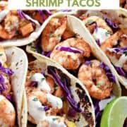 Four grilled shrimp tacos with papaya mango salsa on a wooden plate with title graphic across the top.