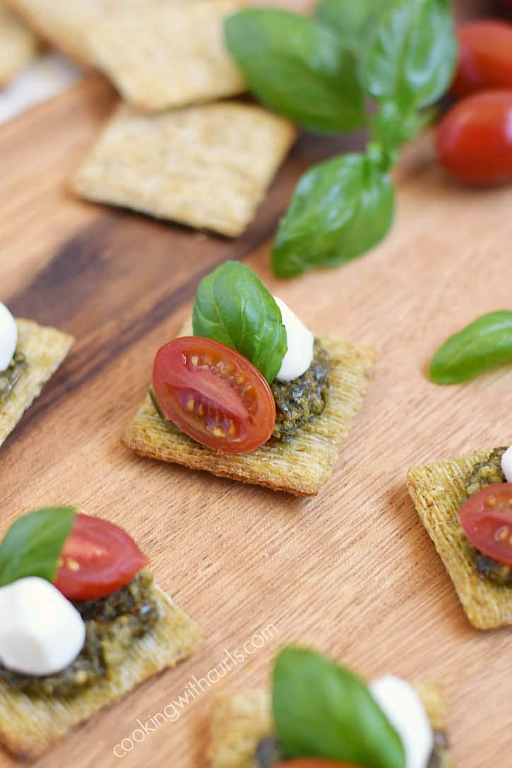 Impress your guests with these fun and delicious TomatoPestoCheesecuit {aka Caprese Bites} appetizers at your next dinner party! cookingwithcurls.com