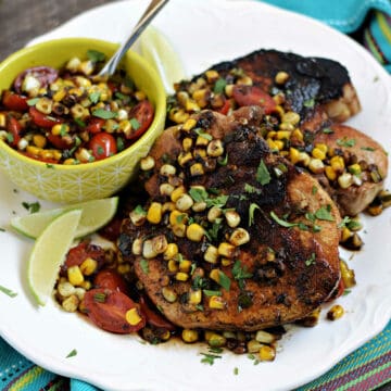 Southwest Pork Chops topped with sweet corn pan sauce, and cherry tomatoes.