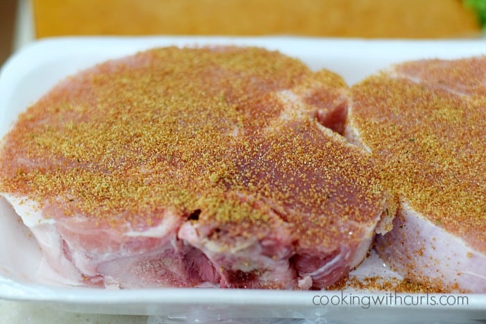 Two thick pork chops rubbed with southwest seasoning.