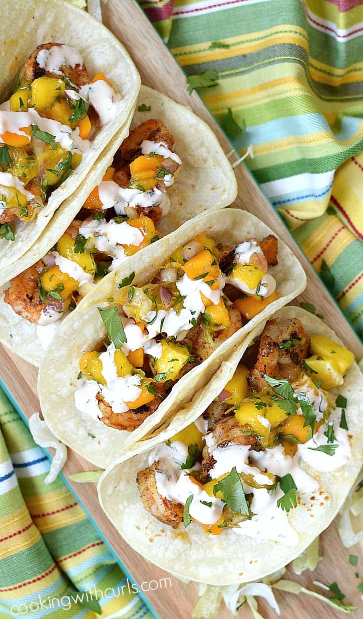 Your family will love these Grilled Shrimp Tacos topped with fresh papaya mango salsa and chipotle crema, then wrapped in a warm corn tortilla | cookingwithcurls.com
