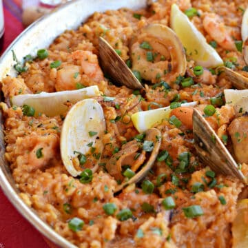 Rice-clams-seafood-and-lemon-wedges-in-a-paella-pan.