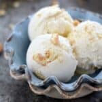 Sweet vanilla ice cream with swirls of lemon curd and vanilla wafers make this Lemon Cheesecake Ice Cream a delicious summer treat | cookingwithcurls.com