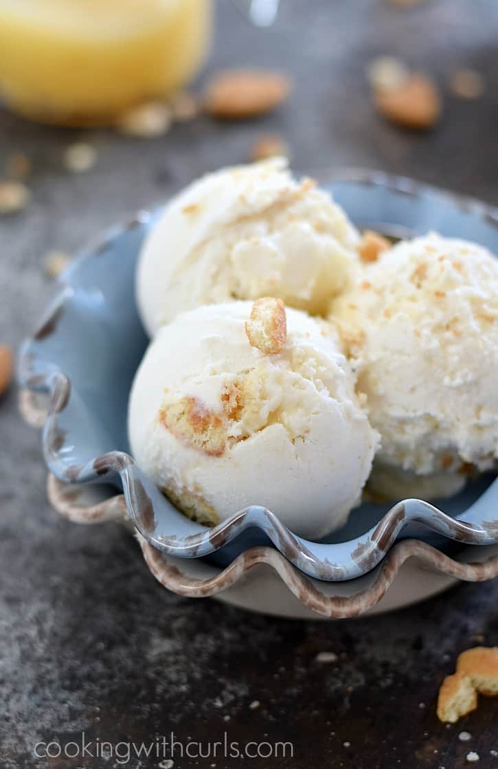 Sweet vanilla ice cream with swirls of lemon curd and vanilla wafers make this Lemon Cheesecake Ice Cream a delicious summer treat | cookingwithcurls.com