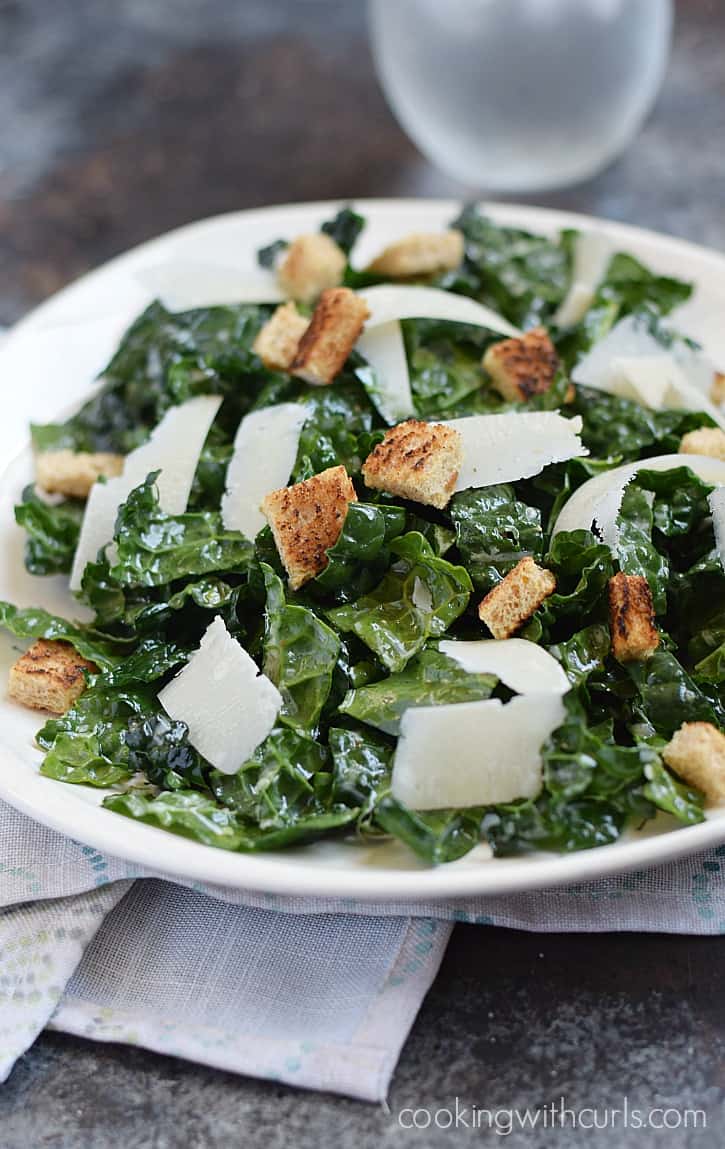 A delicious Black Kale Salad with a light dressing, topped with shaved Parmesan and whole wheat croutons is the perfect light summer meal | cookingwithcurls.com