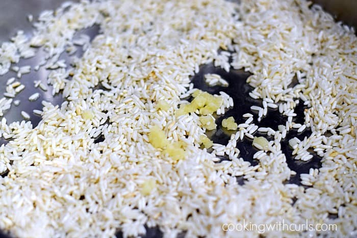 Browned rice and minced garlic in a large skillet.